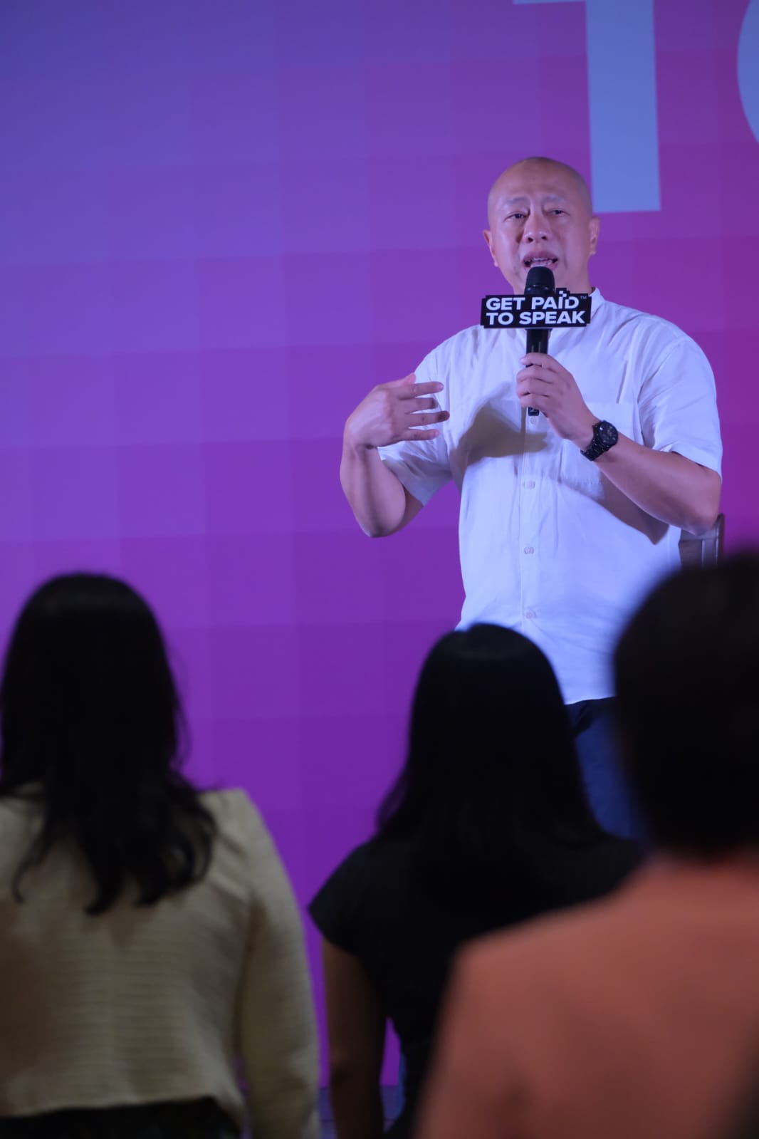 Nadam speaking on stage